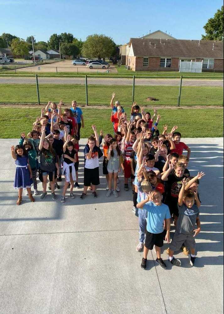 4th grade students standing in the shape of the number 4