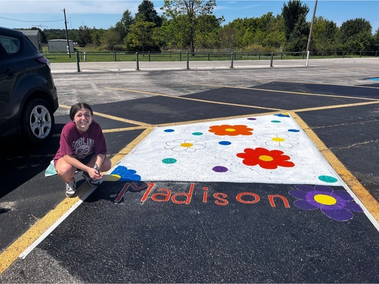 Senior class member with their completed parking spot. 